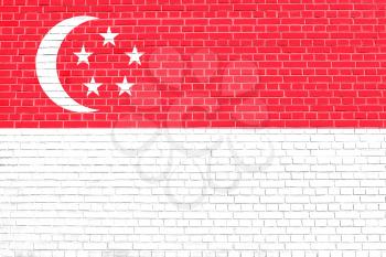 Flag of Singapore on brick wall texture background. Singapore national flag.