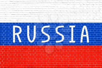 Flag of Russia on brick wall texture background. Russian national flag. Word Russia.