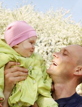 Dad and daughter playing outdoors in spring