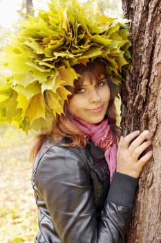young woman wearing a wreath of autumn leaves