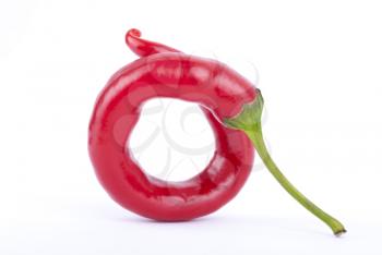 Twisted pod of red pepper chili on a white background.