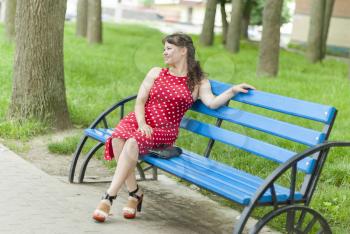 Beautiful girl on a bench in the park.