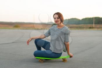 Sport girl with skateboard.