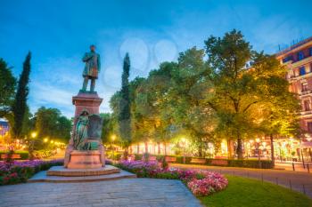 Night View Of Esplanade Park. Statue Of Johan Ludvig Runeberg in Helsinki, Finland