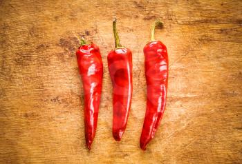Red Hot Chili Peppers On Old Wooden Table Surface Texture Background