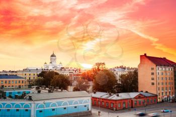 Cityscape And Helsinki Cathedral At Sunset With Dramatic Sky, Finland. Yellow Orange Red Colors