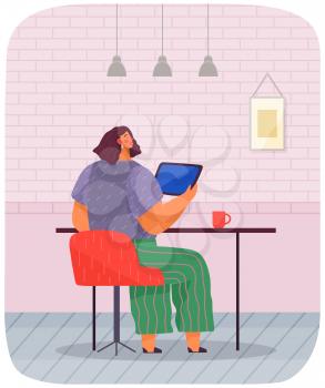 Young woman sitting in comfortable armchair with tablet. Freelancer, remote work. Home office. Student studies online. Business woman at desk working on laptop computer. Secretary in office workspace