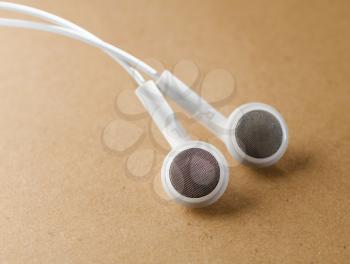 white Headphones, concept of digital music, on  background a light brown paper