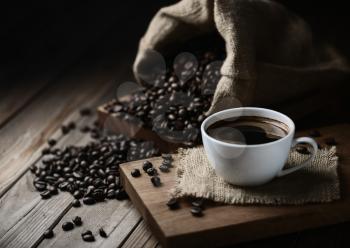 coffee cups and coffee beans on a wooden table