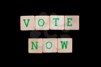 Letters on wooden blocks (now, vote)