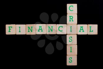 Letters on old wooden blocks (financial, crisis)