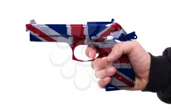 Pistol with UK flag pattern in hand, isolated on white background