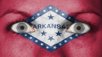 Close up of eyes. Painted face with flag of Arkansas