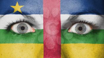 Close up of eyes. Painted face with flag of the Central African Republic