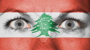 Close up of eyes. Painted face with flag of Lebanon
