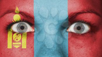 Close up of eyes. Painted face with flag of Mongolia