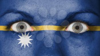 Close up of eyes. Painted face with flag of Nauru