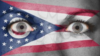 Close up of eyes. Painted face with flag of Ohio