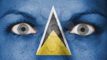 Close up of eyes. Painted face with flag of Saint Lucia