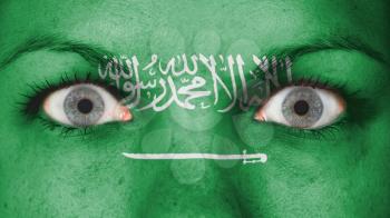 Close up of eyes. Painted face with flag of Saudi Arabia
