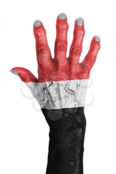 Hand of an old woman wrapped in flag of Yemen