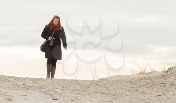 Lonely photographer walking on a beach in Holland