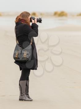 Lonely photographer walking on a beach in Holland