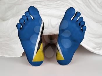 Feet with flag, sleeping or death concept, flag of Saint Lucia