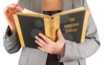 Woman reading a marriage almanac, saving her marriage
