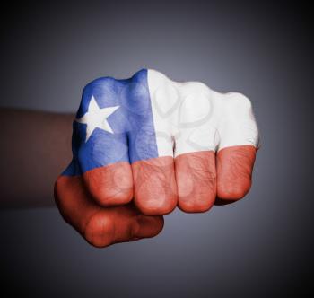 Front view of punching fist on gray background, flag of Chile