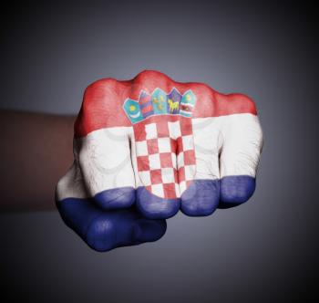 Front view of punching fist on gray background, flag of Croatia