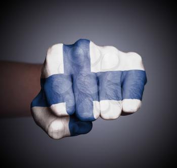 Front view of punching fist on gray background, flag of Finland