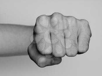 Fist of a man punching, black and white
