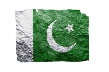 Close up of a curled paper on white background, print of the flag of Pakistan