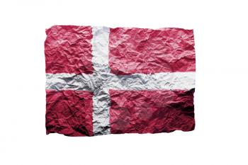 Close up of a curled paper on white background, print of the flag of Danmark