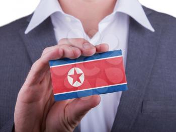 Businessman showing card, matte paper effect, North Korea