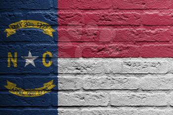 Brick wall with a painting of a flag isolated, North Carolina