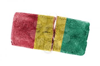 Rough broken brick, isolated on white background, flag of Guinea