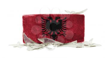 Brick with broken glass, violence concept, flag of Albania