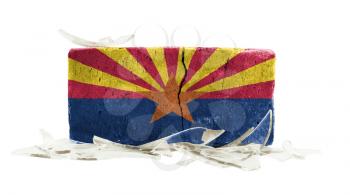 Brick with broken glass, violence concept, flag of Arizona
