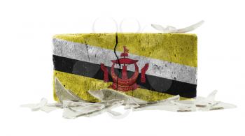 Brick with broken glass, violence concept, flag of Brunei