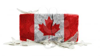 Brick with broken glass, violence concept, flag of Canada