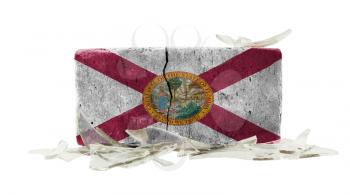 Brick with broken glass, violence concept, flag of Florida