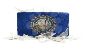 Brick with broken glass, violence concept, flag of New Hampshire