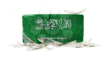 Brick with broken glass, violence concept, flag of Saudi Arabia