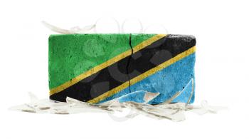 Brick with broken glass, violence concept, flag of Tanzania
