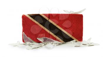 Brick with broken glass, violence concept, flag of Trinidad and Tobago