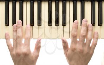 Piano keyboard with hands on white background