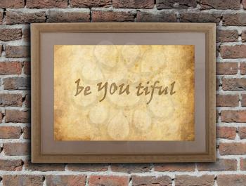 Old wooden frame with written text on an old wall - Be YOU tiful