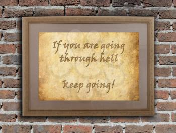 Old wooden frame with written text on an old wall - Keep going